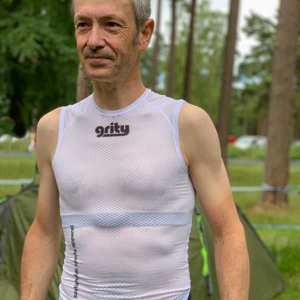 Man wearing base layer standing in the woods